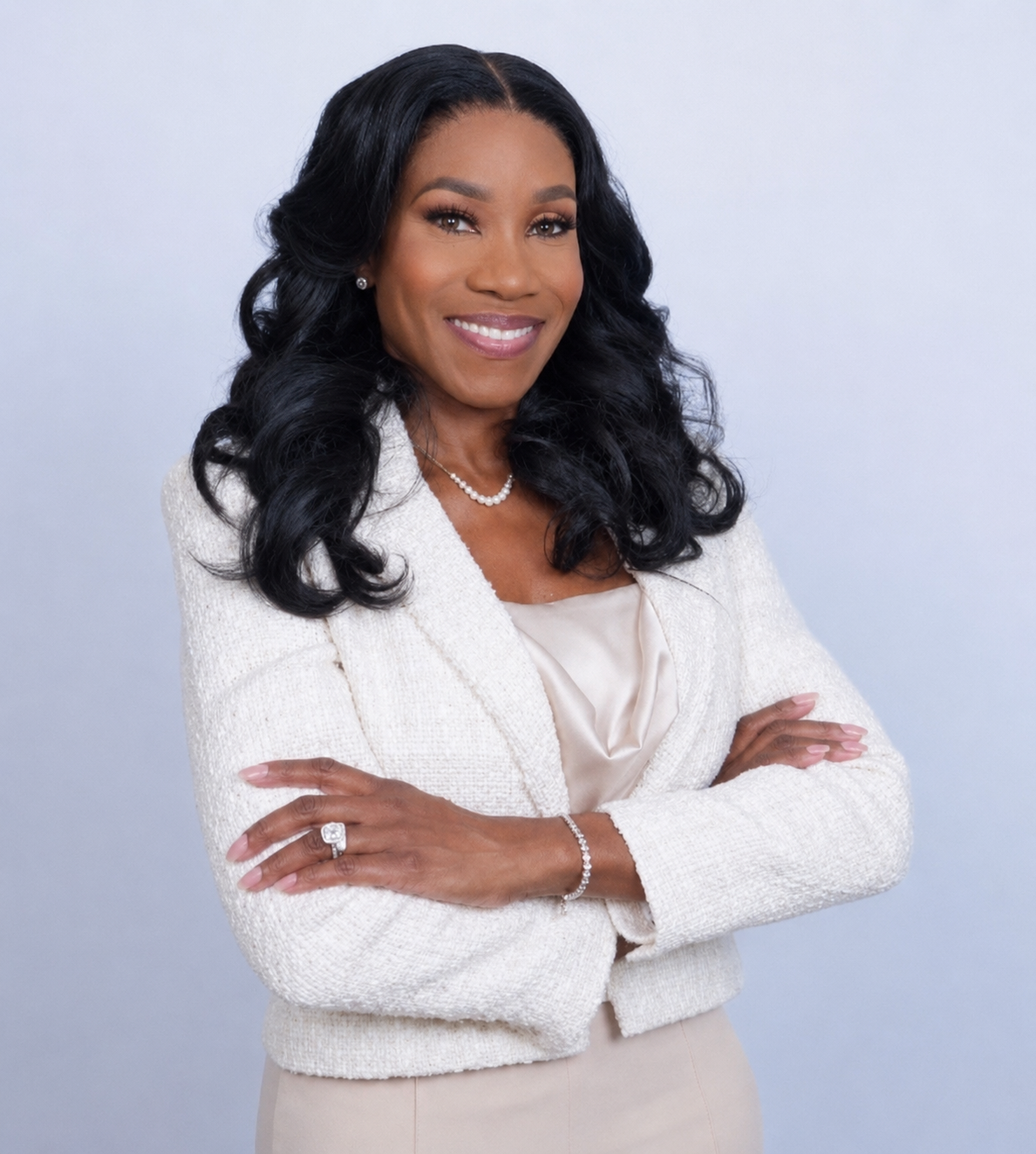 Lady Michelle Connor smiling with her arms folded, wearing an ivory jacket